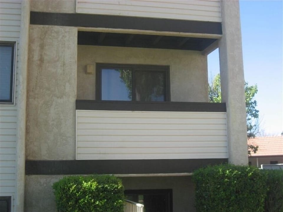 Condo deck with chairs, 1/2 floor from ground level