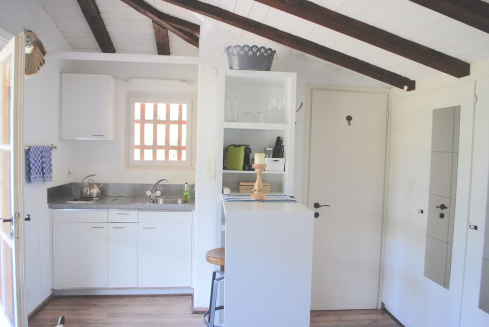 Kitchenette, dining bar and door to bathroom