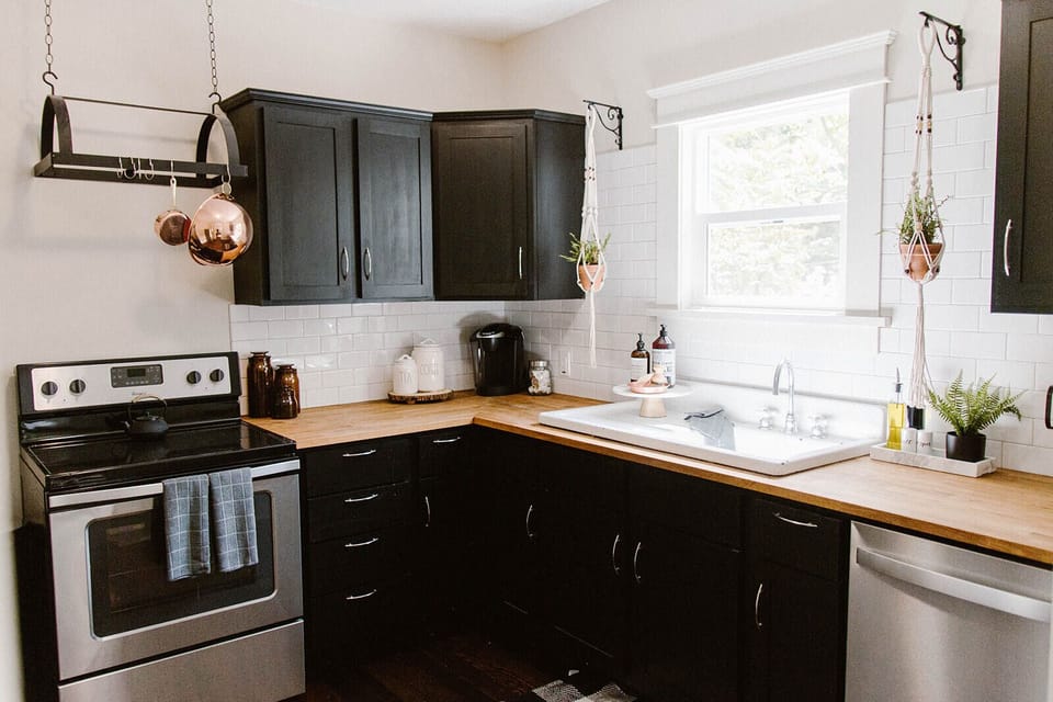 Kitchen has dishes, silverware, and cooking essentials.  