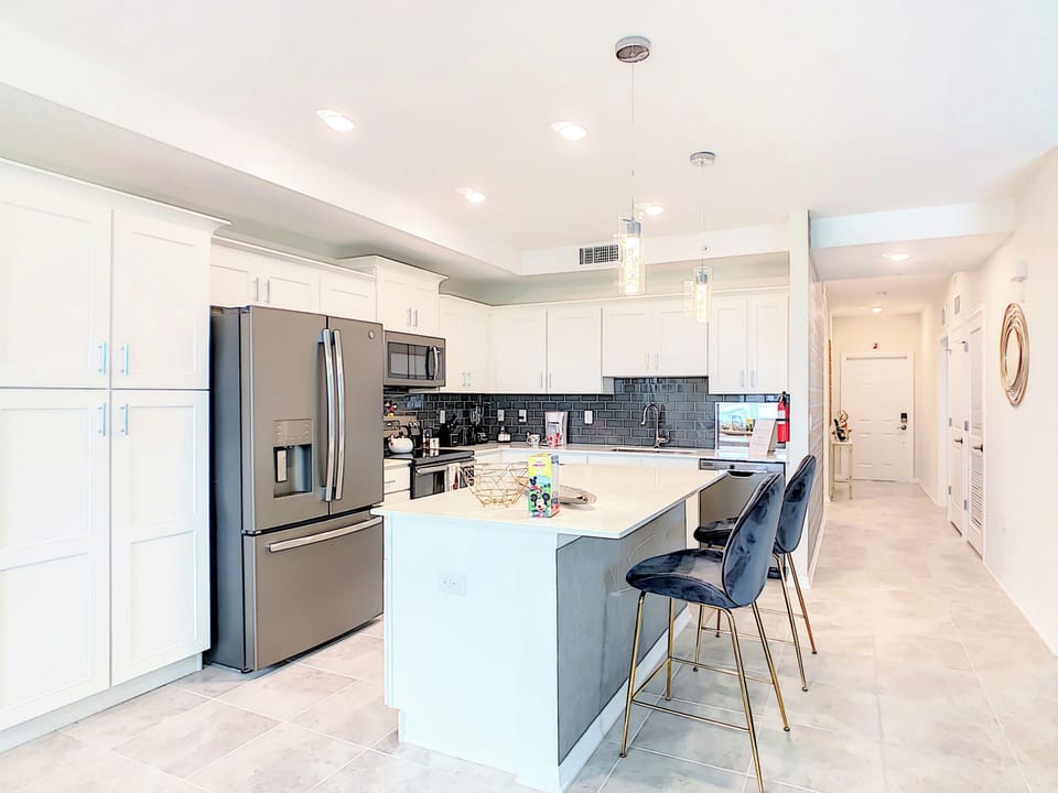 Modern kitchen with stainless steel appliances and island seating