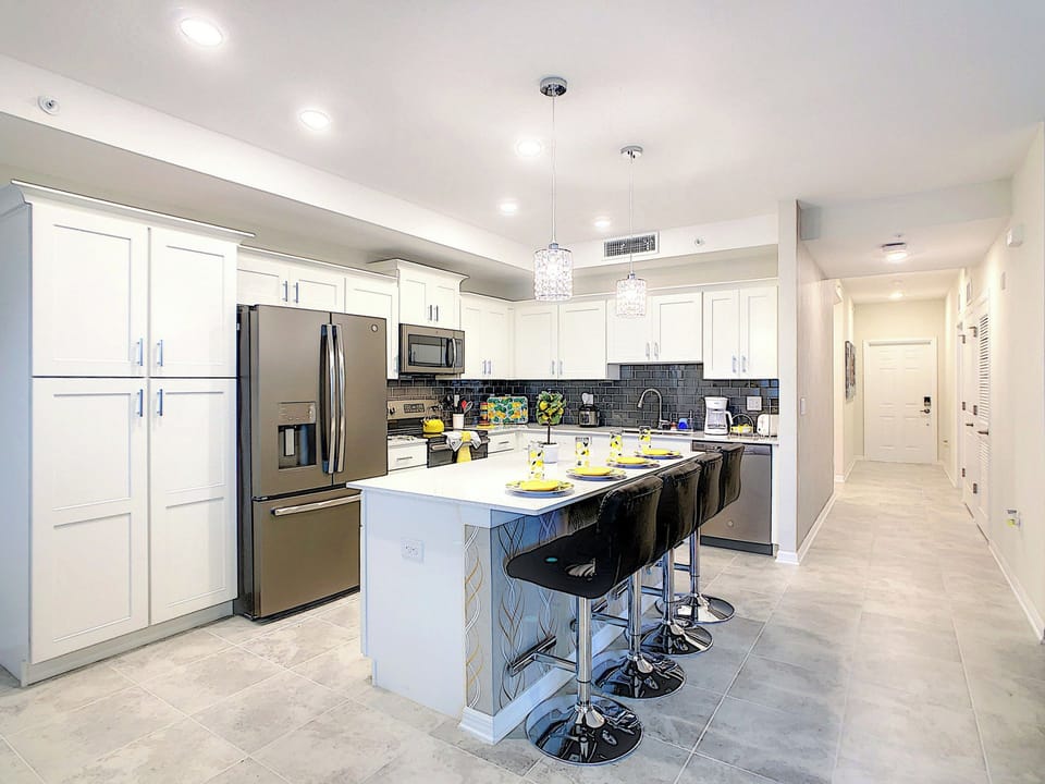 Modern kitchen with island breakfast bar and stainless appliances