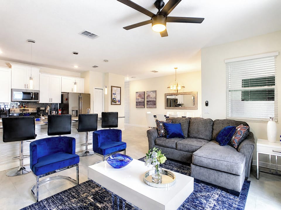 Open-Concept Living Area with Plush Seating and Modern Kitchen