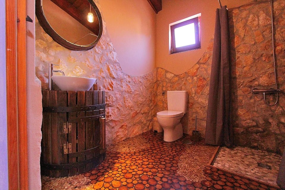 Bath/Shower. A wine lovers bathroom - featuring an old wine press sink and wine corks in the flooring