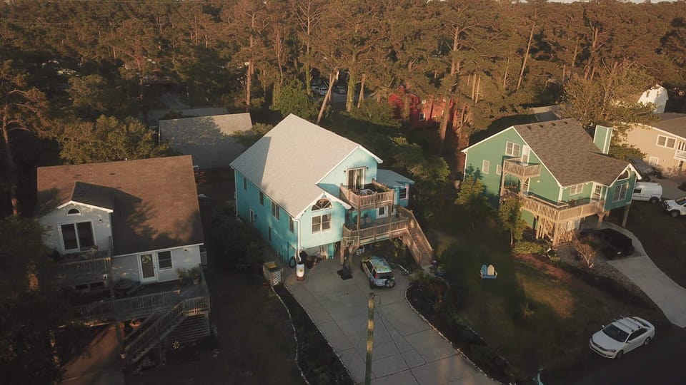 Blue center house.  The beach is .5 miles  behind the house.  