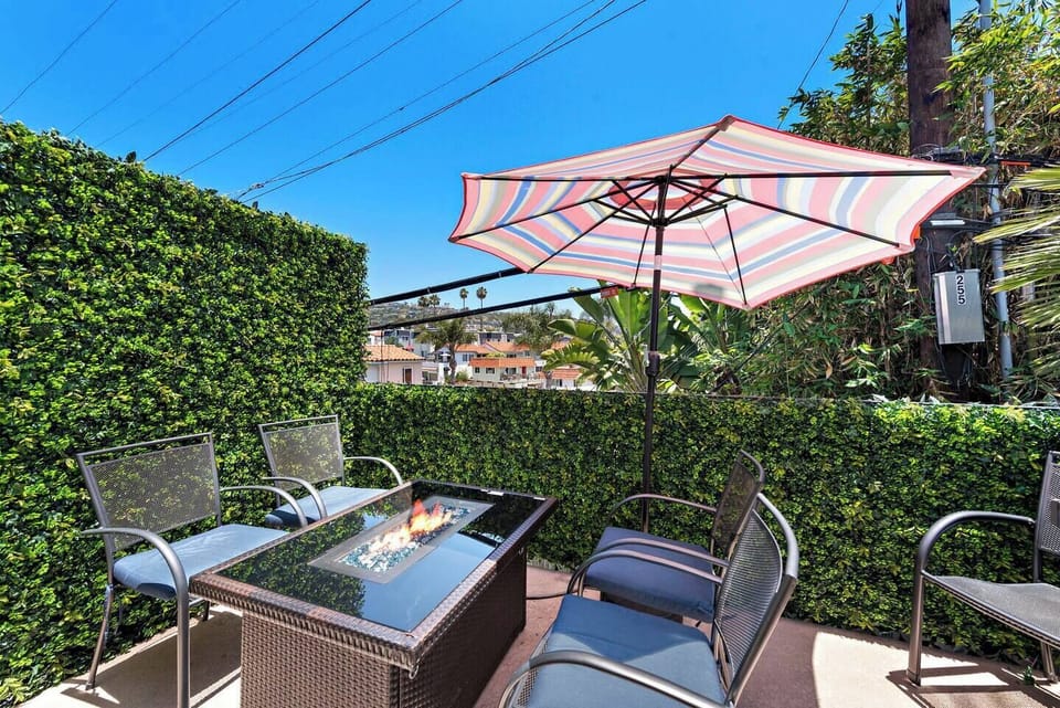 The private outdoor patio has a gas grill and chairs. This balcony almost counts as shared space as you will likely hear the guests below in the backyard