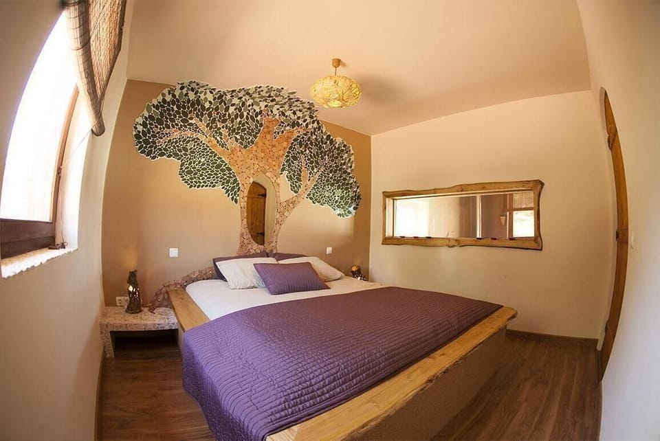 Sleeping area. Nature inspired bedroom featuring mosaic art and handmade decor