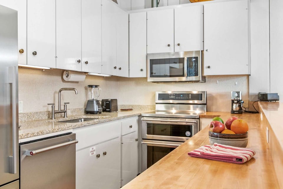Beautiful kitchen with new stainless appliances, granite and butcher block countertops are found in the kitchen.