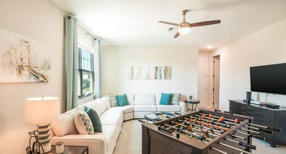 Stairs lead to the 2nd living room with a TV and foosball table.