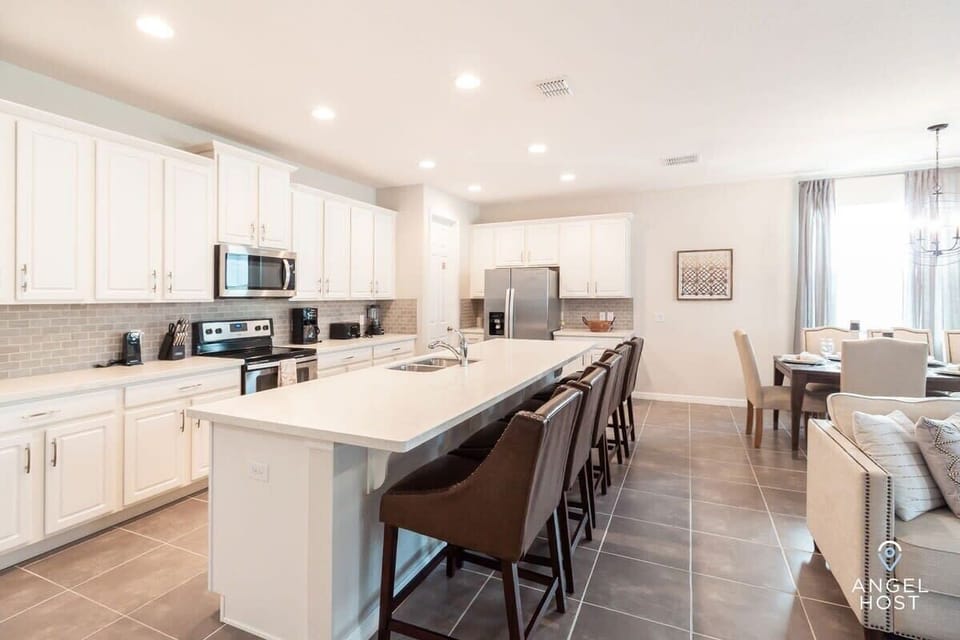 Kitchen island with a dishwasher and seating for five. All dishes, glasses, flatware, and cookware provided.
