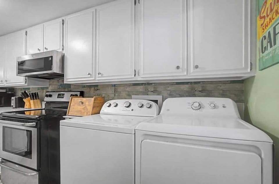 Convenient laundry area offers ample cabinet storage for your convenience.
