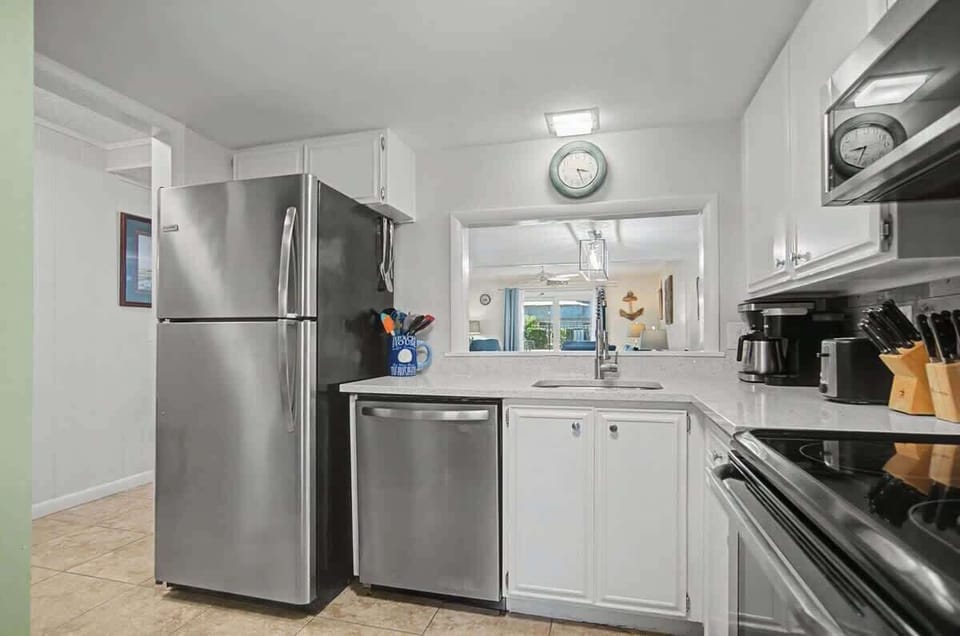 Spacious and well-appointed kitchen featuring full-size appliances, ample counter space, and all the cookware and essentials needed to prepare meals with ease during your stay.
