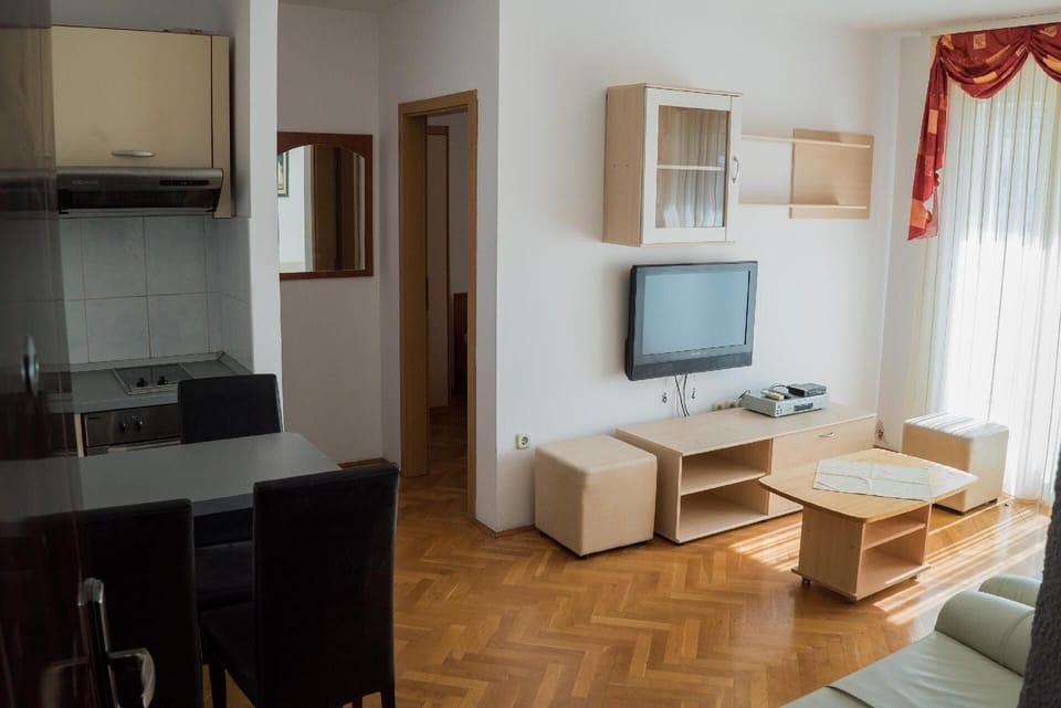 The view from the entrance of the apartment on livingroom, kitchen and door of the bedroom