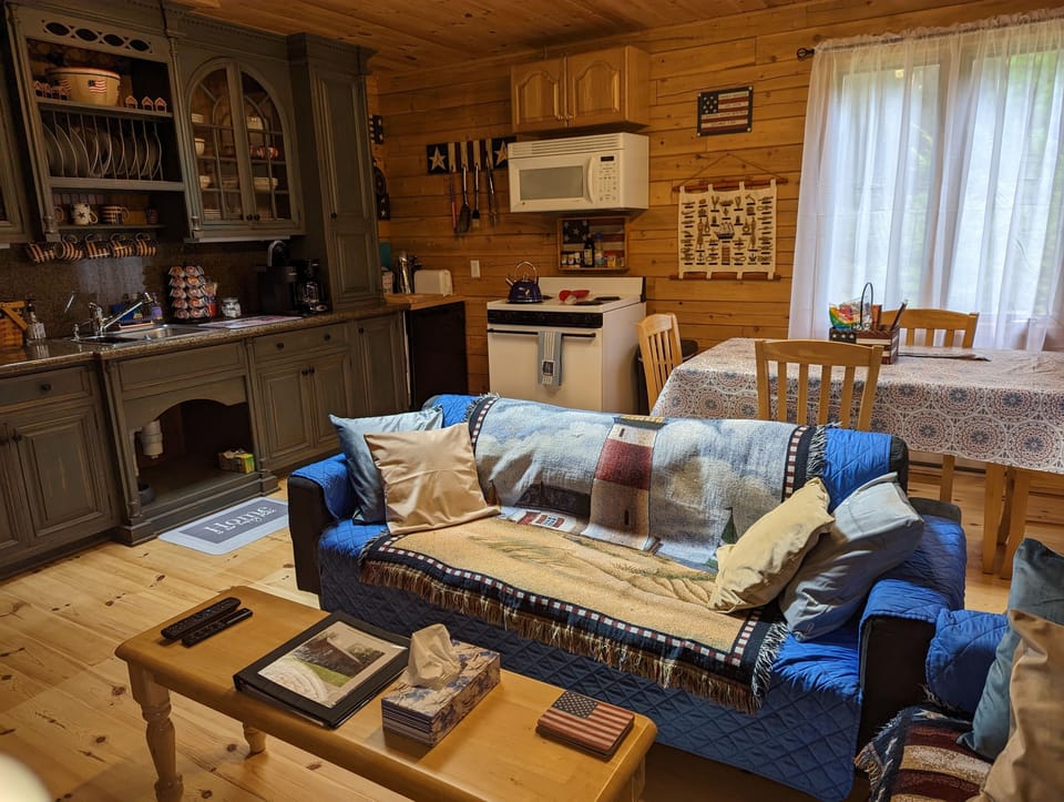 Open concept living area with baseboard heat and a full kitchen