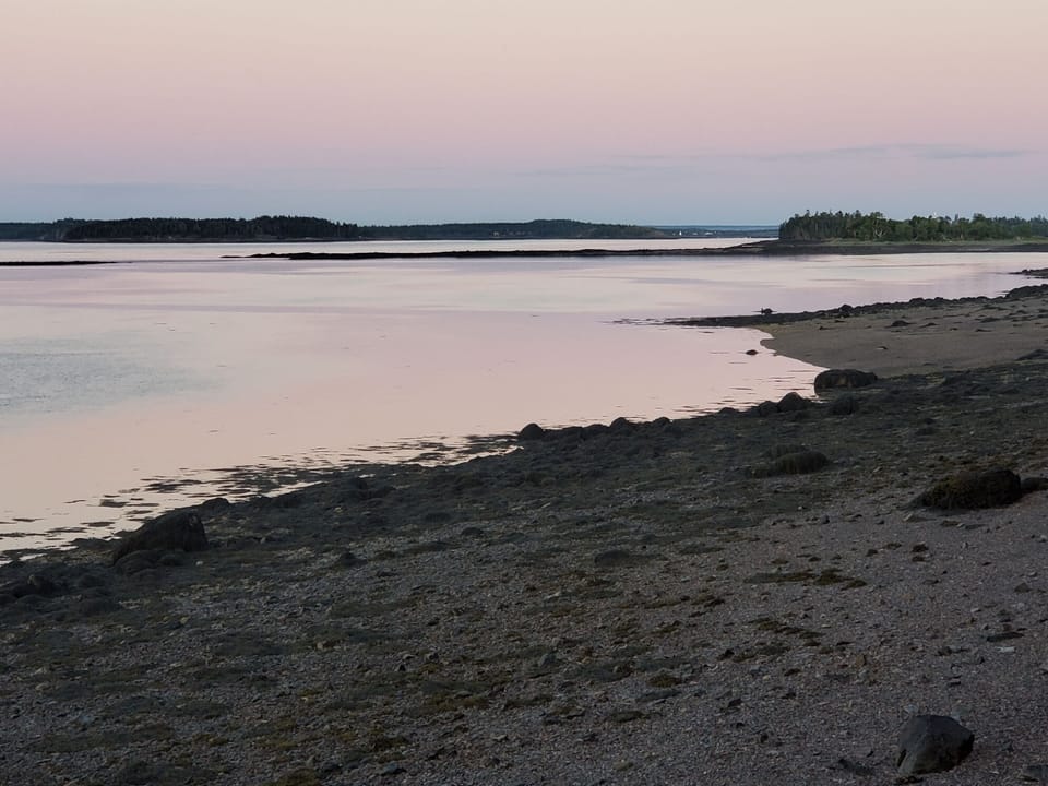 Evening beach view with a signature lavender sunset