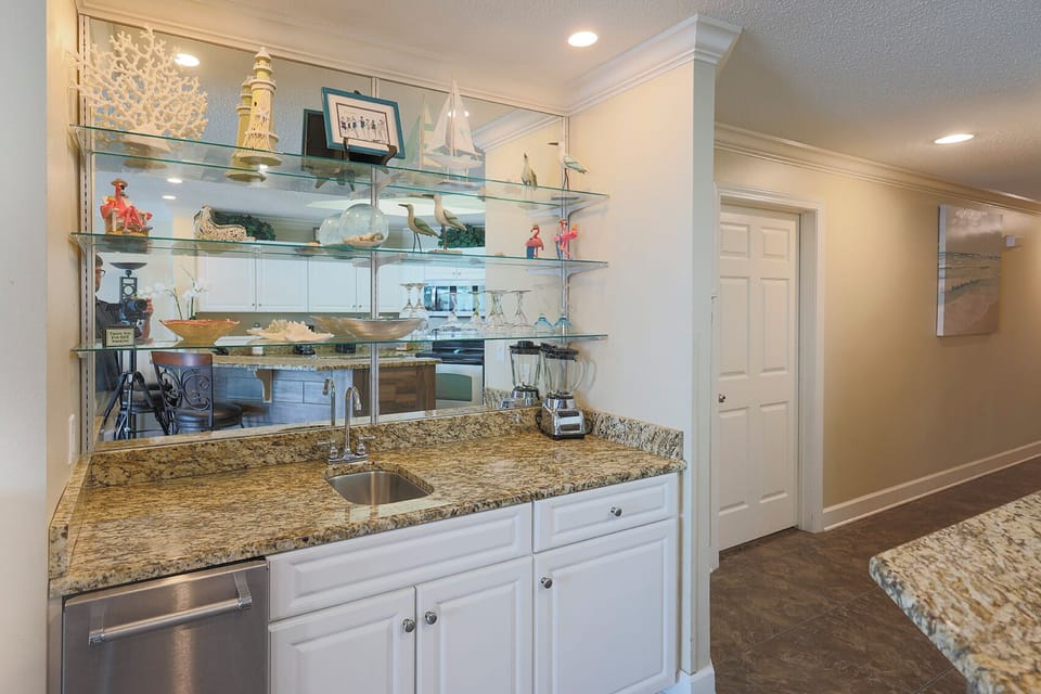 Enjoy preparing refreshments at the stylish wet bar, where family gatherings come alive with laughter and conversation