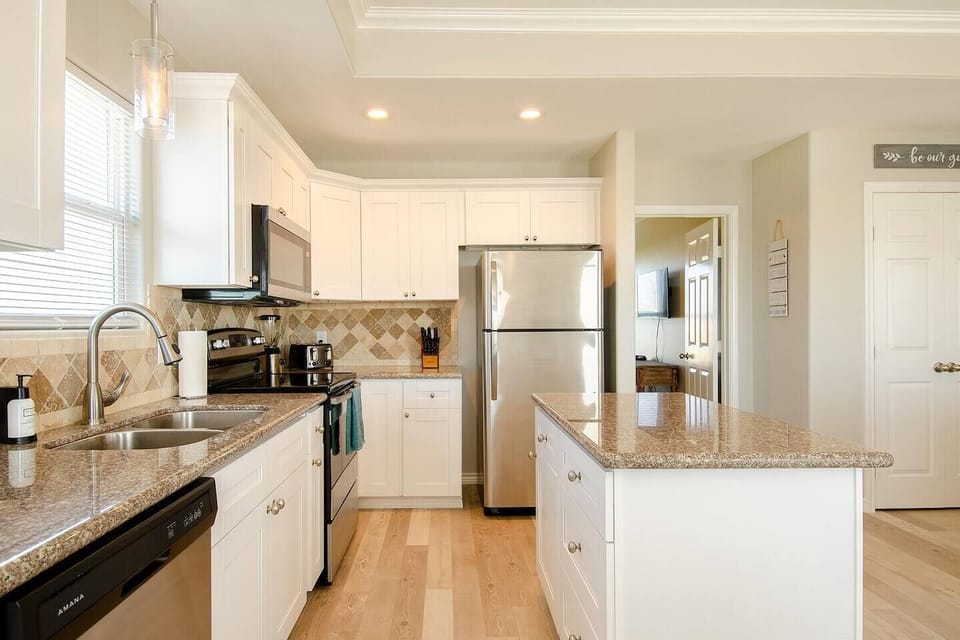 Updated kitchen includes modern appliances and full cooking essentials.