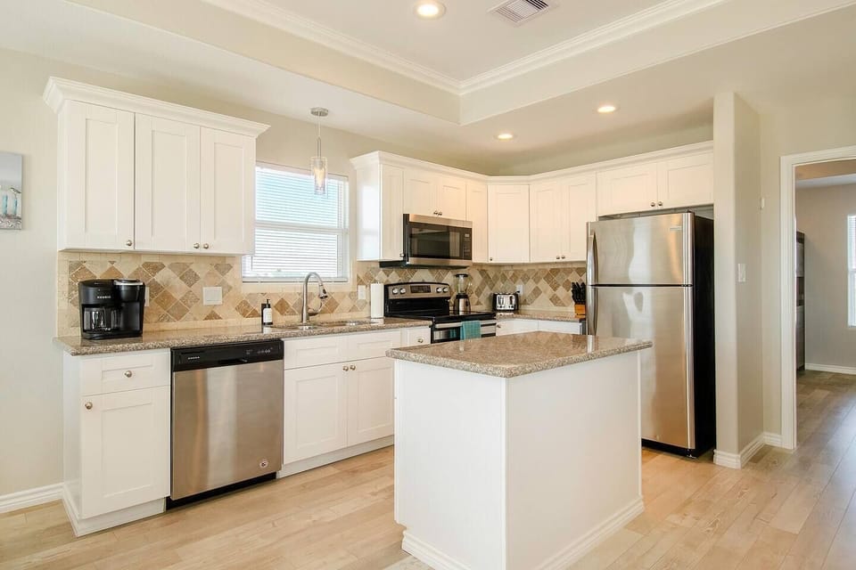 Spacious open kitchen perfect for cooking meals during your beach getaway.