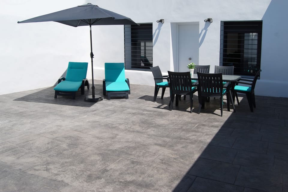 Terrace with sun loungers and barbecue