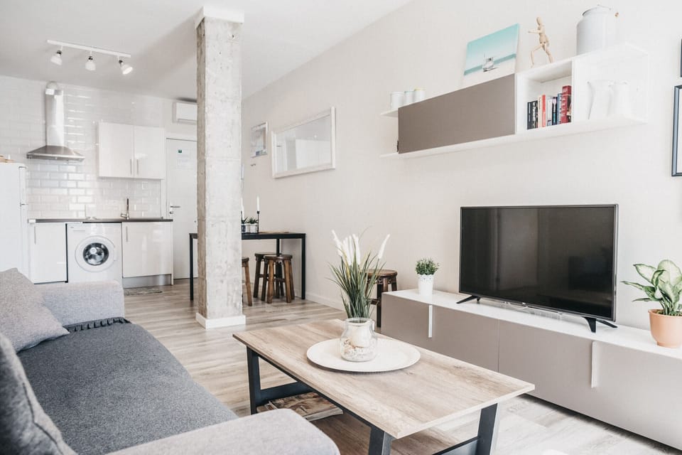 Bright living room with sofa, air conditioning, and all the comforts