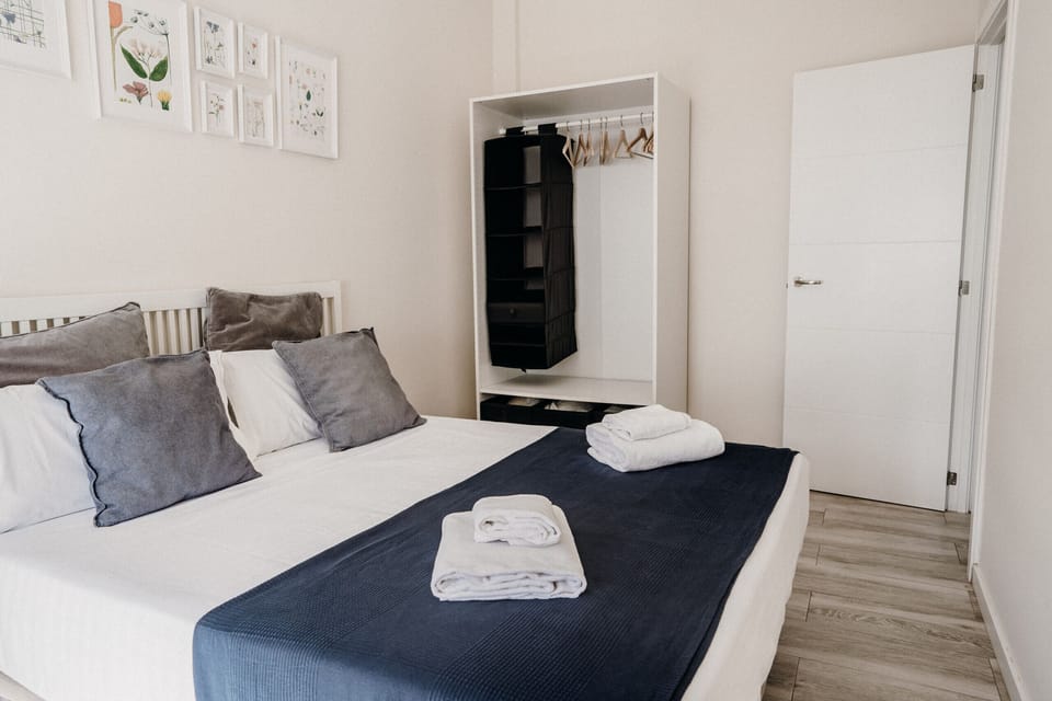 Modern and bright bedroom with double bed and balcony overlooking the beach