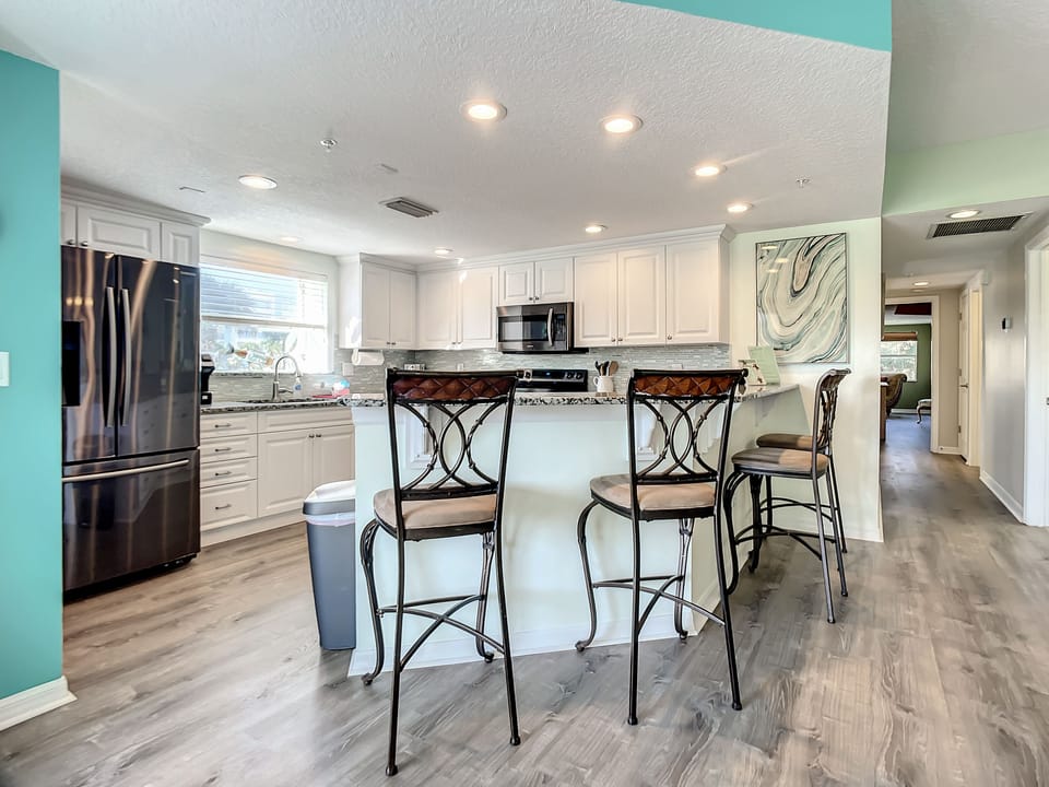 4 High Top Stools sit near the counter for breakfast on-the-go!