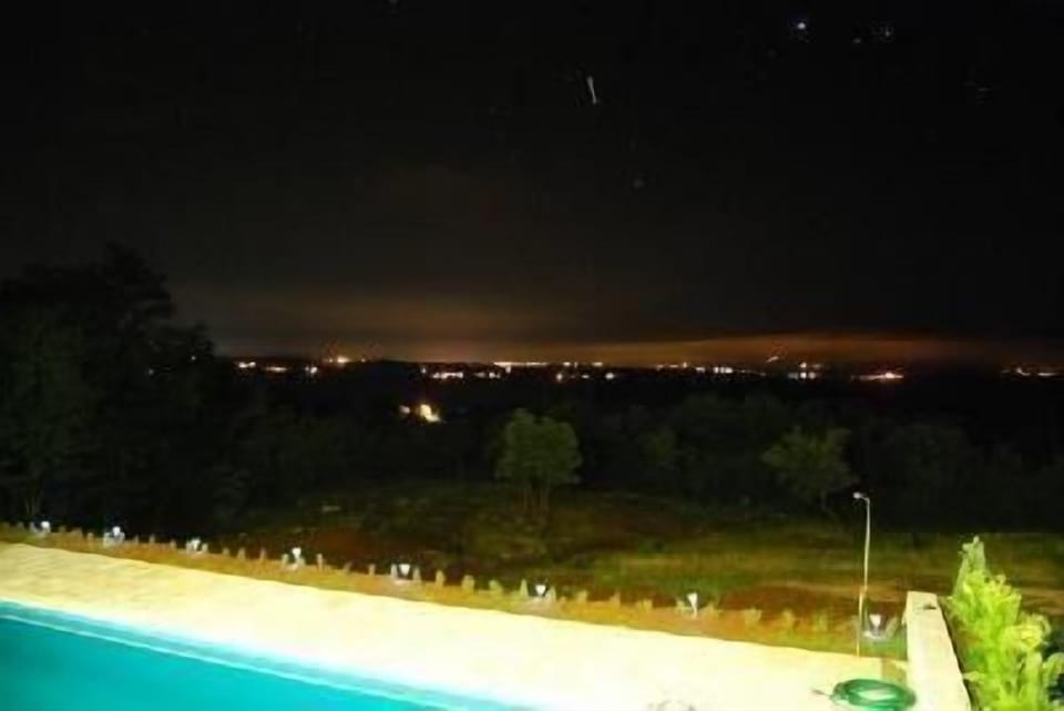 Night view looking from pool area, looking west towards Labin