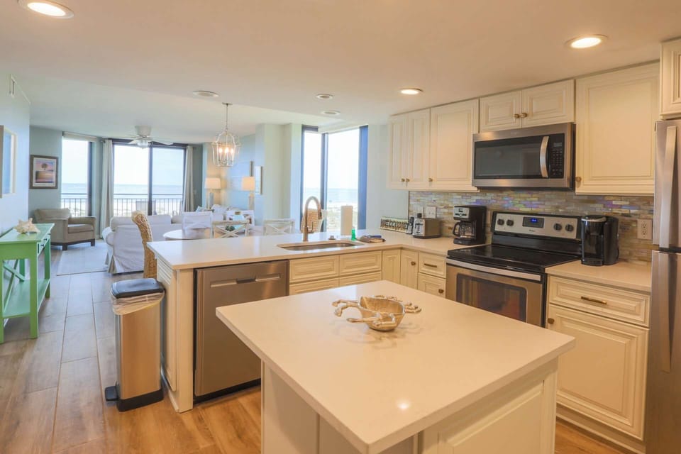 The kitchen features a central island and plenty of room for your family to prepare their meals.