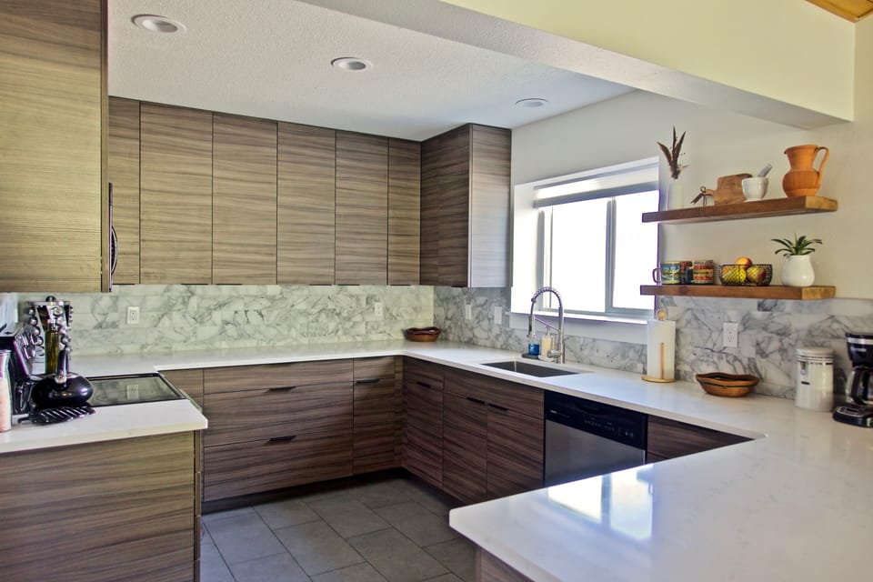 Remodeled kitchen stocked with blender, electric tea kettle, toaster, and more