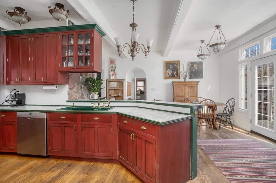 Hang out in the big kitchen while the chef cooks up his latest creation. 8 places at the antique table and 4 countertop stools makes this a lively spot.