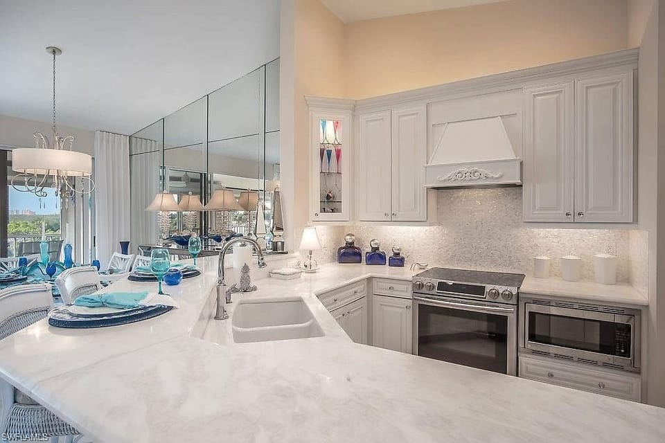 Gorgeous marble counter tops adorn the eat-in kitchen bar