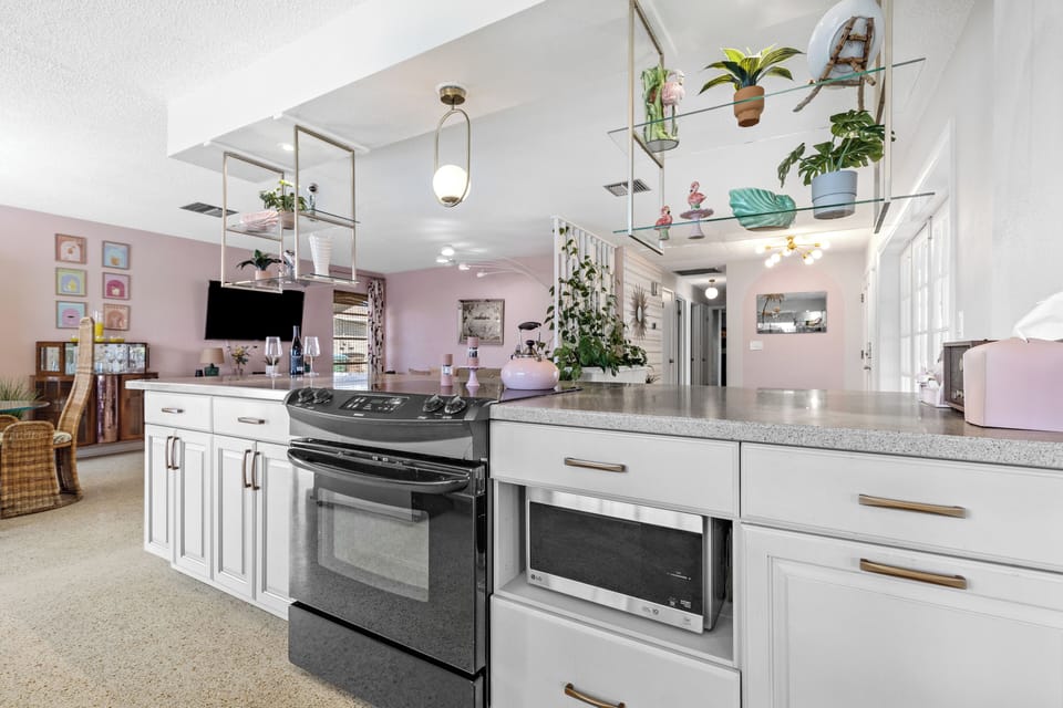 Kitchen bar with stove and microwave.