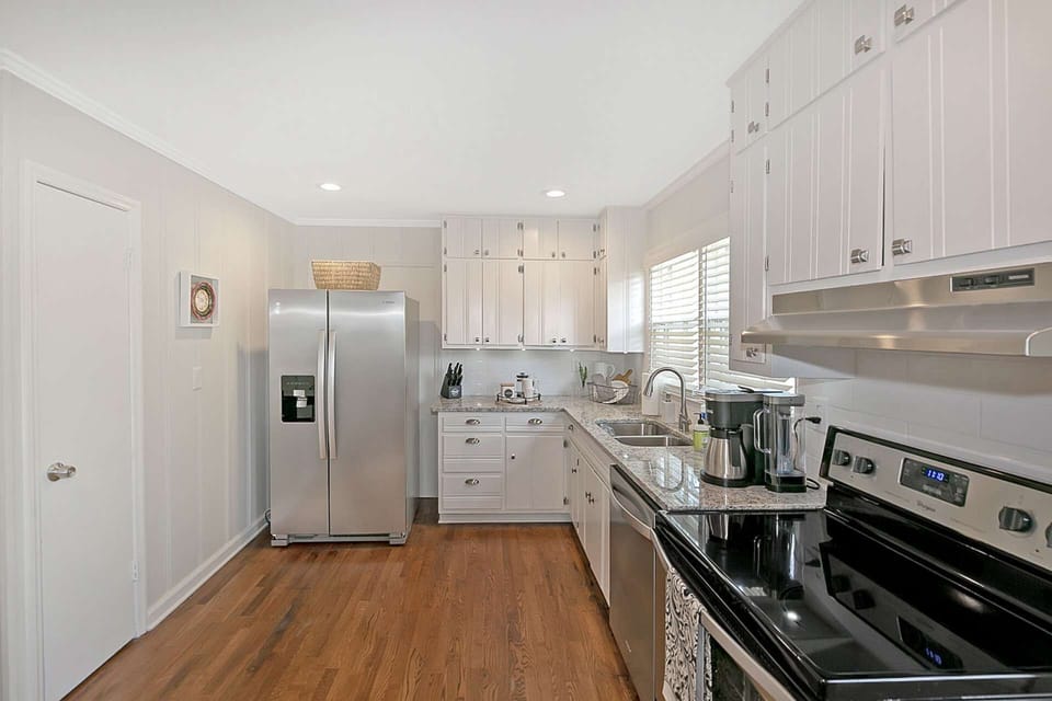 Stainless steel appliances in the kitchen, to the left is the breakfast room, cook on electric stove