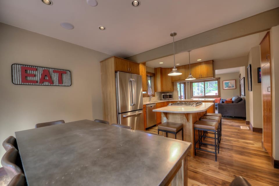 Dining room table with seating for 8 and an additional 4 seats at the bar top
