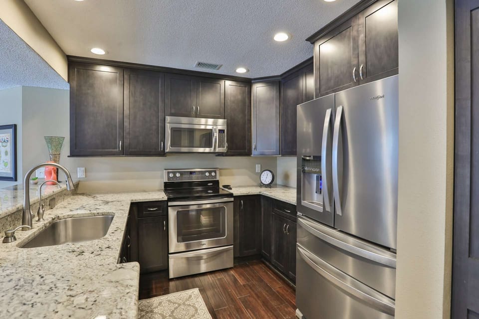 Modern kitchen with stainless steel appliances and granite counter tops.