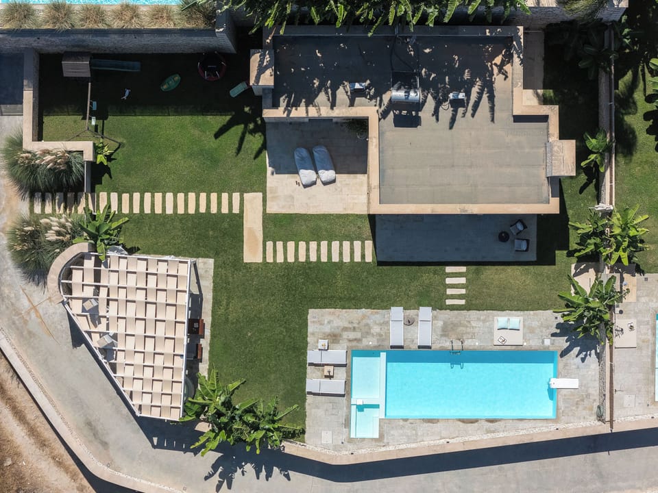 The villa nestles gracefully within Crete’s countryside.