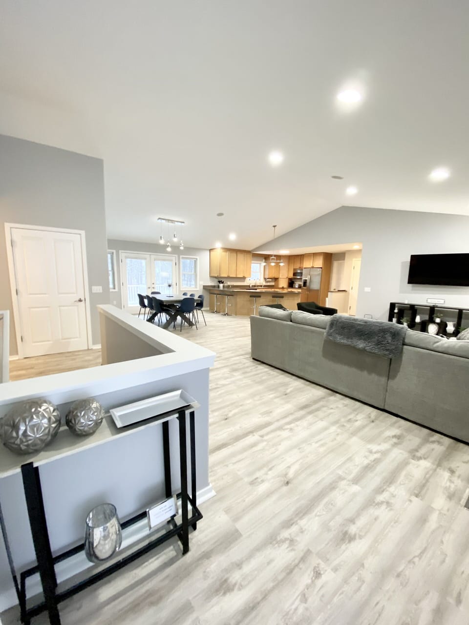 View of great room, dining area and kitchen from back patio entry. 