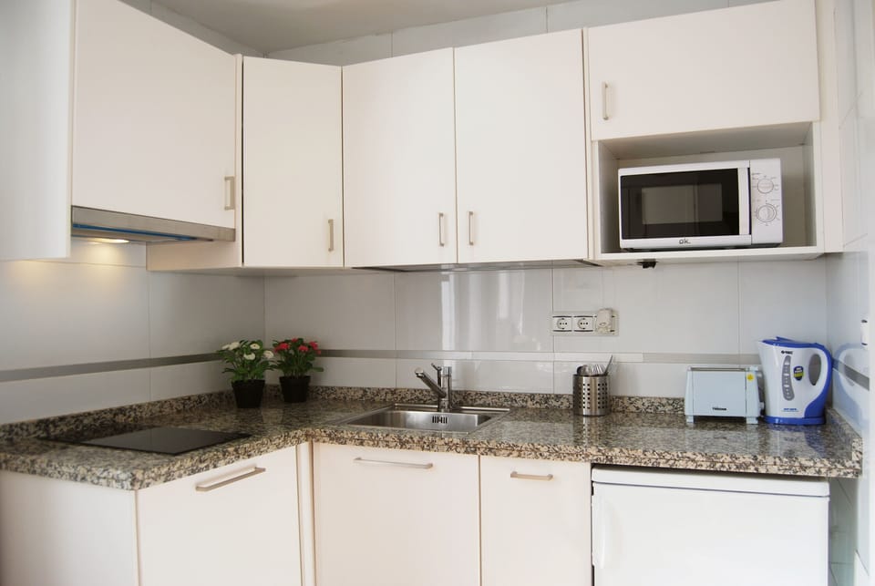 Kitchen with everything you need for cooking, toaster, coffee maker and microwave