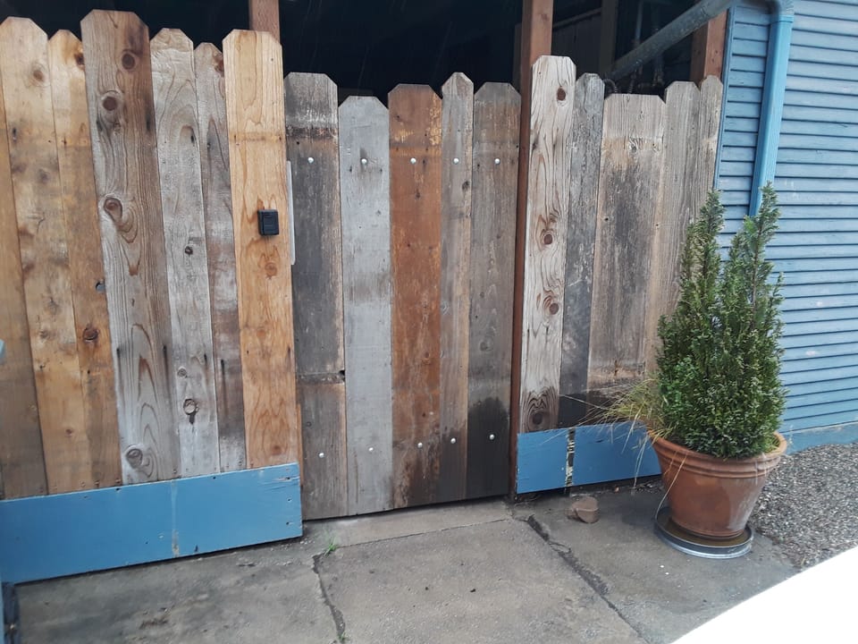 Gate with lock to the patio that leads to the front door.