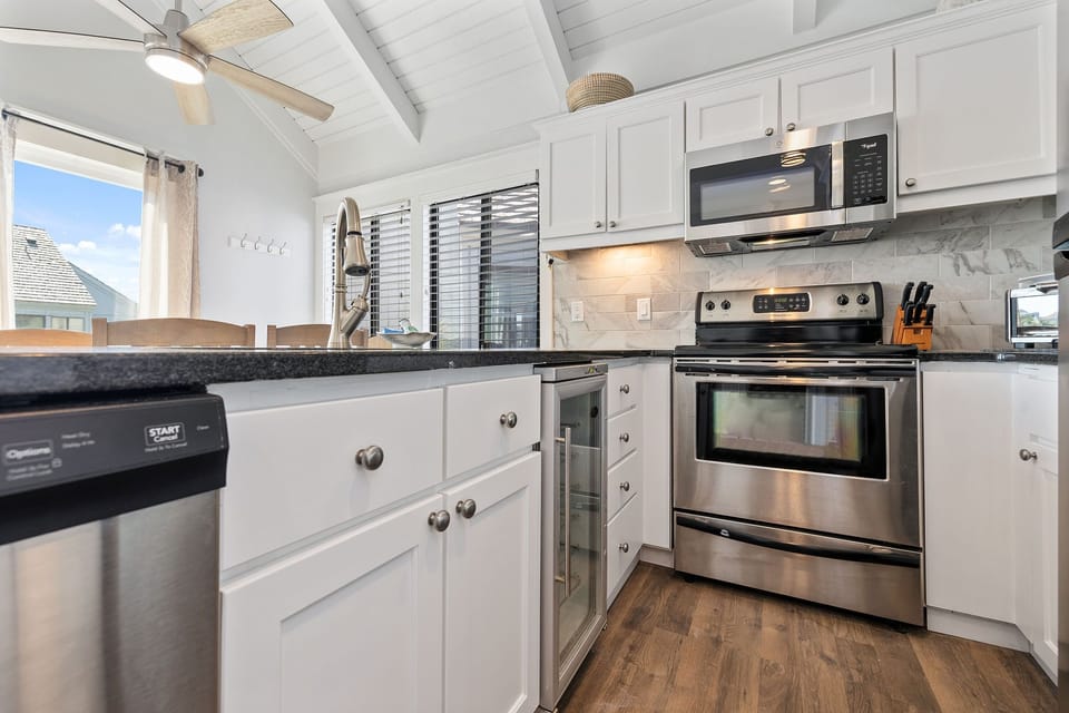 Kitchen open to dining area and living room with access to porch