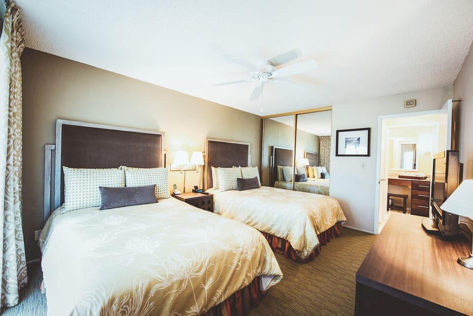 Stretch out together in a spacious room with cozy bedside lamps.