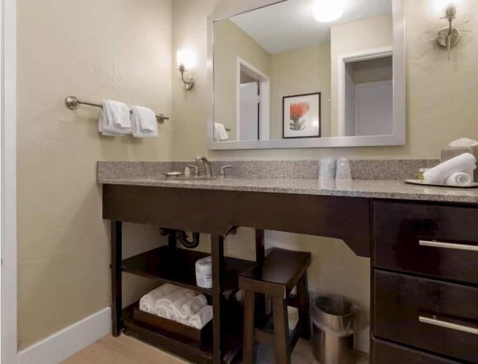 Get ready with a wide granite vanity and bright mirror lighting.