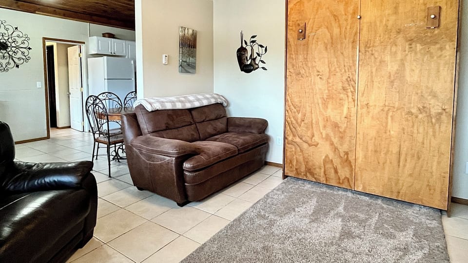 Living room with murphy bed looking toward dining and kitchen areas