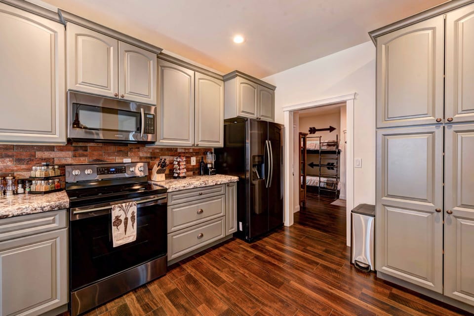 Downstairs kitchen with door leading to bunk beds and upstairs