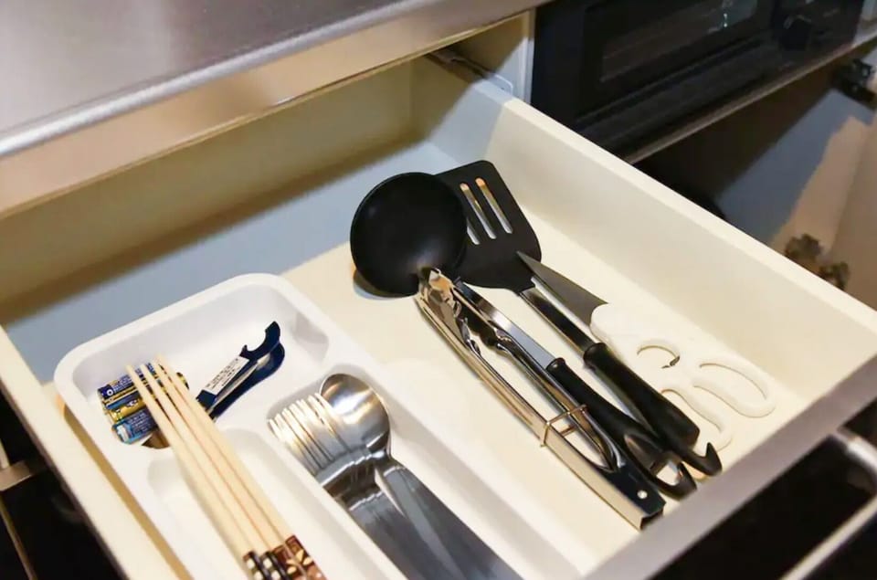 There are various cooking utensils in the drawer