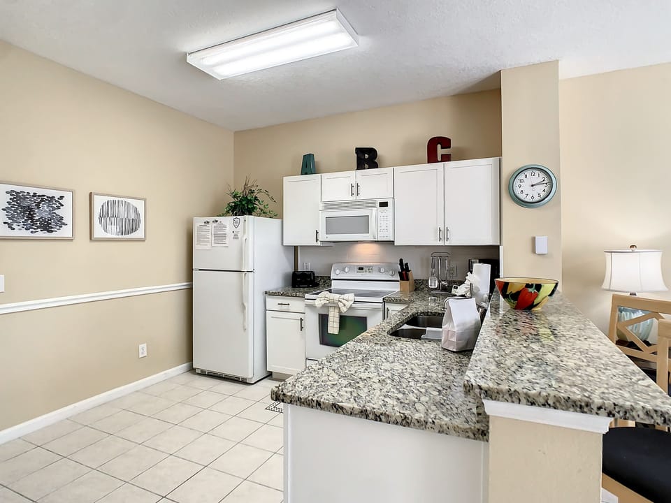 Spacious kitchen with modern appliances, ample counter space, and a bright dining area.