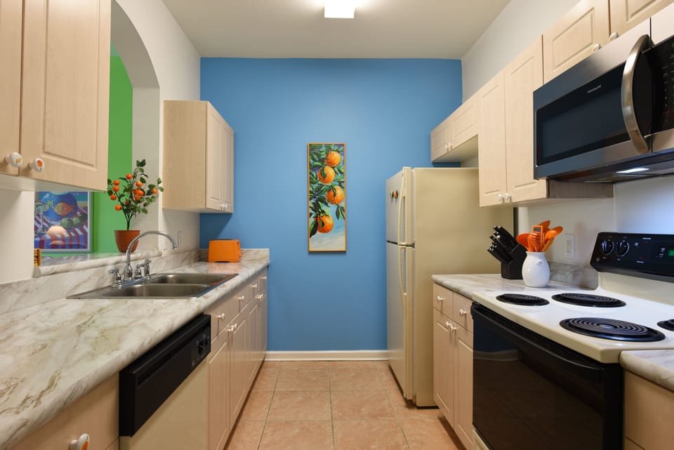 Modern kitchen with a stylish accent wall and all the essentials for your cooking needs.