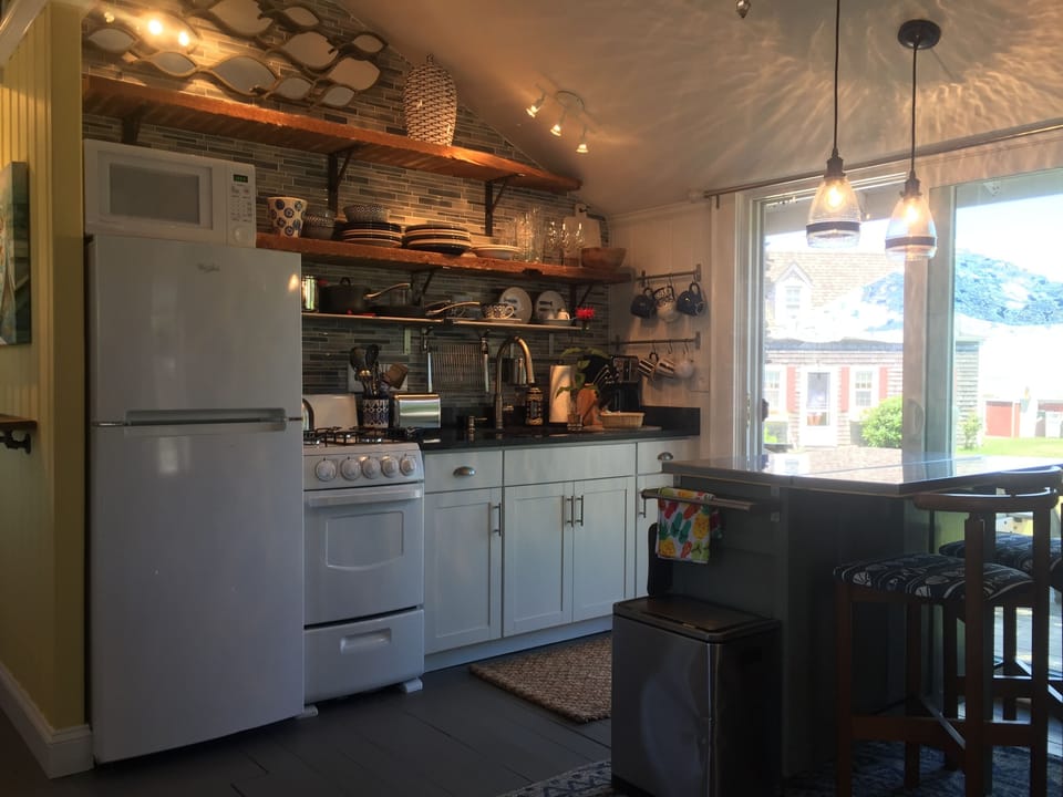 Beautifully updated & fully stocked open concept kitchen flows to rear deck