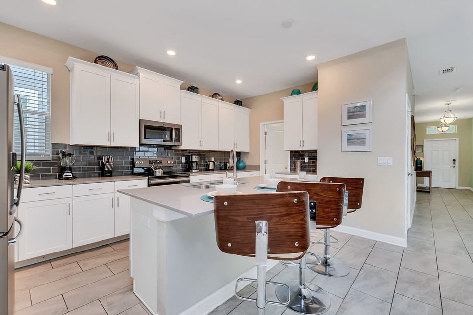 Sleek Kitchen of the Home in Davenport Florida - A chef's dream space where cooking becomes a pleasure - Step into our chef-inspired kitchen - Top-of-the-line appliances and premium fixtures for culinary excellence49