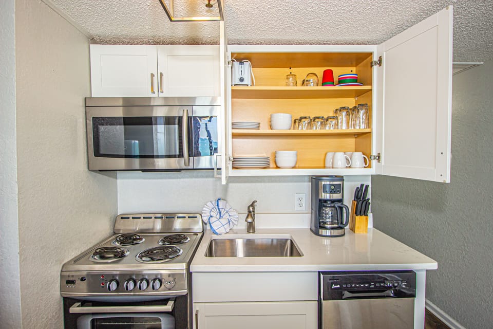 Fully stocked cabinets.  Plenty of dishes, cups and bowls.