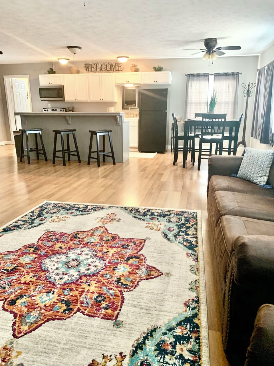 Open living room/kitchen area. The living room sofa is a queen sleeper sofa.